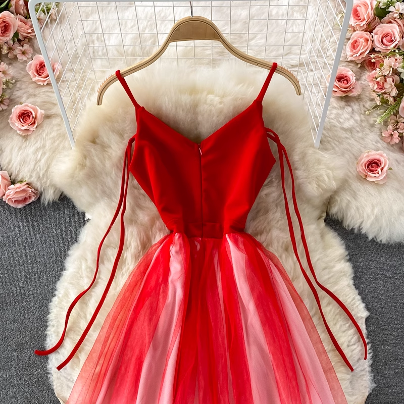 Close-up of the bodice and upper skirt of a red and white gradient tulle dress