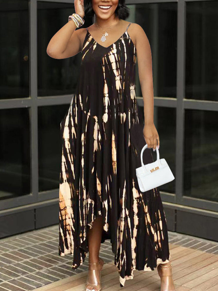 Woman wearing a black and white tie-dye maxi dress with spaghetti straps and a v-neckline.