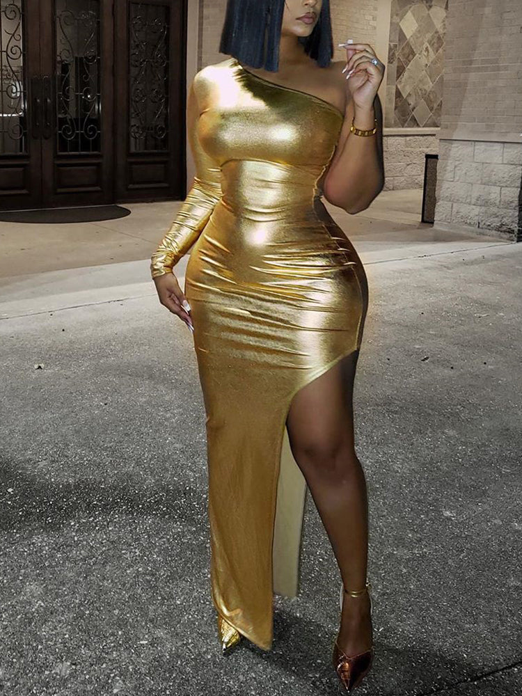 woman in a gold metallic one-shoulder dress with a high slit