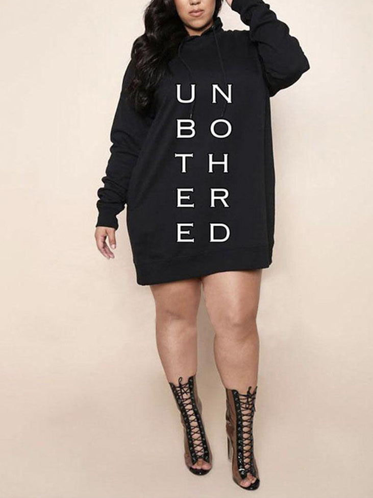 Plus-size model wearing a black hooded dress with 'Unbothered' graphic, and lace-up boots.