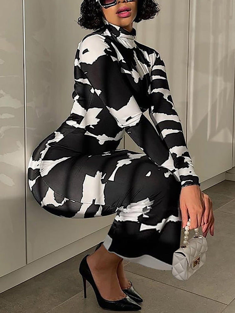 woman in black and white abstract print dress