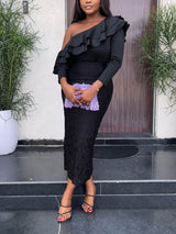 Woman wearing a black one-shoulder dress with ruffle detail and lace skirt, holding a purple clutch in front of her.