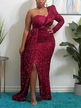 Woman wearing a floor-length, one-shoulder, sequined gown with a high slit in red.