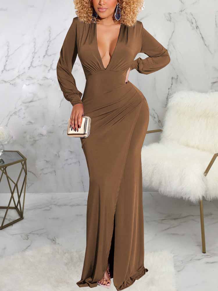 Woman wearing a long brown dress with a deep V-neckline, long sleeves, ruched detailing, and a high slit.