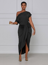 woman wearing a black one-shoulder draped dress with a high slit