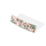 Rectangular barrette with a pink and green marbled pattern, angled view.