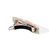 Rectangular barrette with a pink and green marbled pattern, shown from the side, revealing the metal clip mechanism.