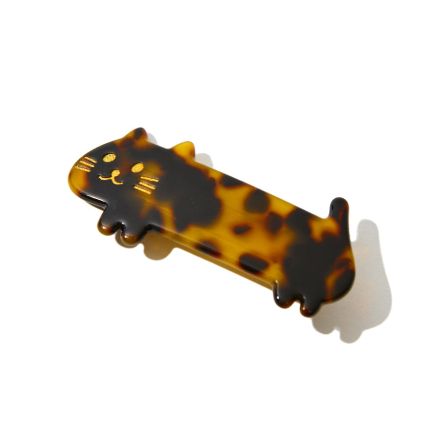 Front view of a tortoiseshell cat-shaped hair clip with gold facial details.