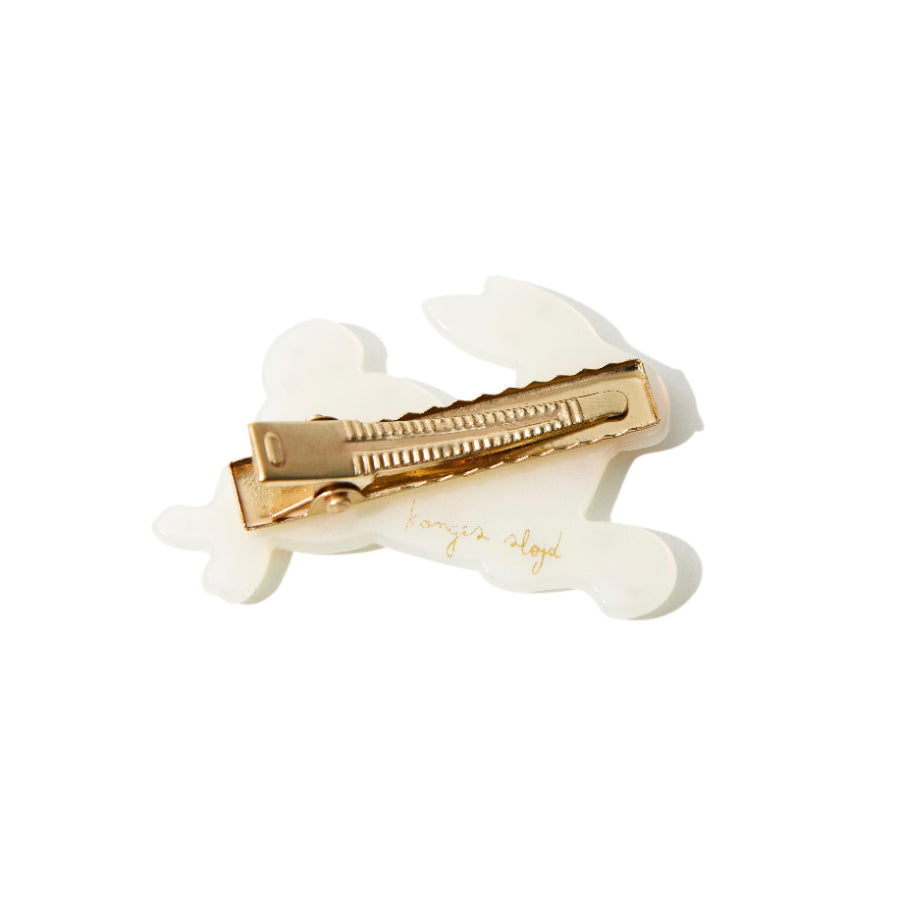 Back view of white resin bunny hair clip with gold alligator clip