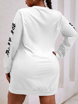 Back view of the white long-sleeve dress showing the plain back and long sleeves
