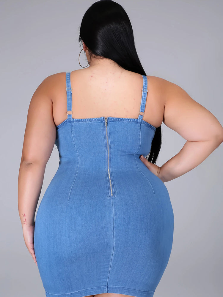 Back view of a woman in a denim sheath dress showing the zipper closure.