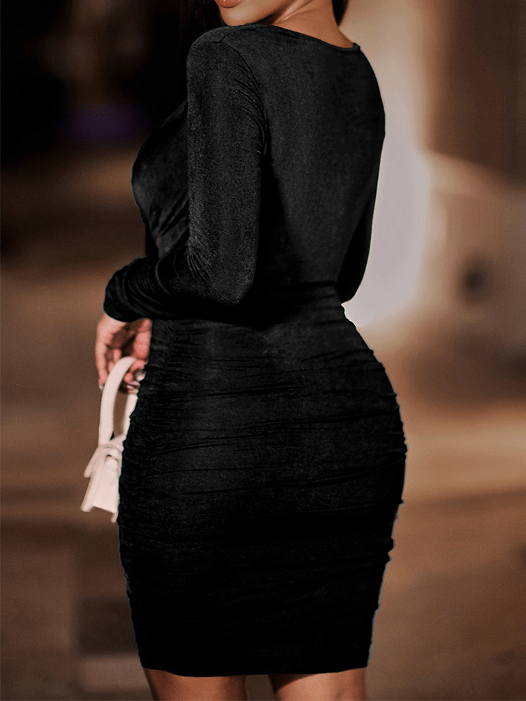 Back view of a woman in a black ruched bodycon dress with a halter neckline and long sleeves.
