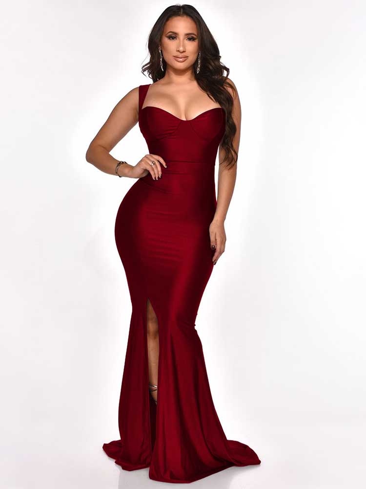 Woman wearing a floor-length, dark red satin mermaid dress with a sweetheart neckline and a high slit, posed from the front.