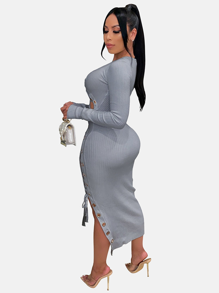 Side view of a woman in a grey ribbed knit midi dress with long sleeves and lace-up detailing.