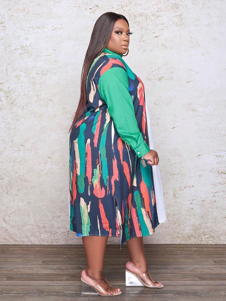 Side view of a plus-size woman wearing a long-sleeved, asymmetrical color block shirt dress with a white side and a printed side.