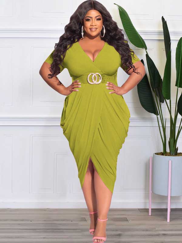 Plus-size model wearing a lime green ruched V-neck short-sleeve dress with a tulip hem and a side slit, paired with black strappy heels.