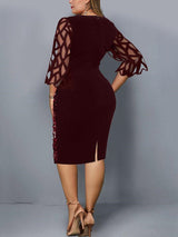 Back view of a woman in a burgundy sequined sheath dress with sheer geometric mesh bell sleeves and a side slit