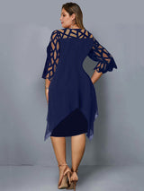 Back view of a plus-size woman wearing a navy blue layered dress with geometric mesh sleeves and an asymmetrical hemline.