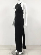 side view of a black floor-length halter dress with a high slit and white floral embellishments on a mannequin
