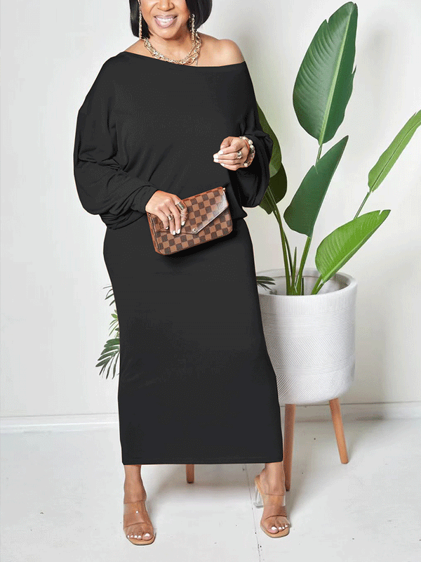 Woman wearing a black off-the-shoulder maxi dress with batwing sleeves