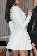 Side view of a woman in a white fitted blazer dress with a pleated skirt.
