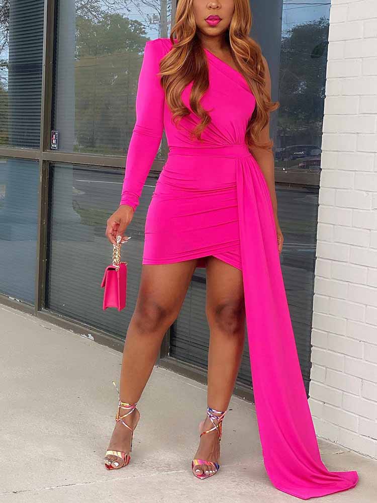woman wearing a hot pink one-shoulder mini dress with a long draped train