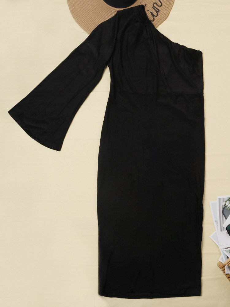 Close-up of the bodice of a black one-shoulder midi dress with a cut-out detail