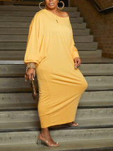 Full-length view of a woman in a yellow off-the-shoulder maxi dress