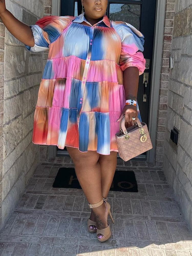 Woman wearing a colorful tie-dye tiered mini dress with puff sleeves and high heels
