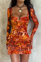 woman wearing an orange long-sleeved mini dress with a square neckline and ruffled hem
