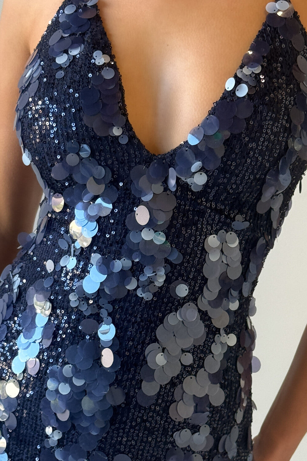 detail shot of the navy blue sequined halter mini dress neckline and bodice