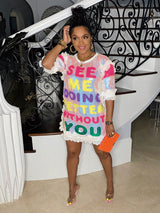Front view of a woman in a sequined t-shirt dress with text.
