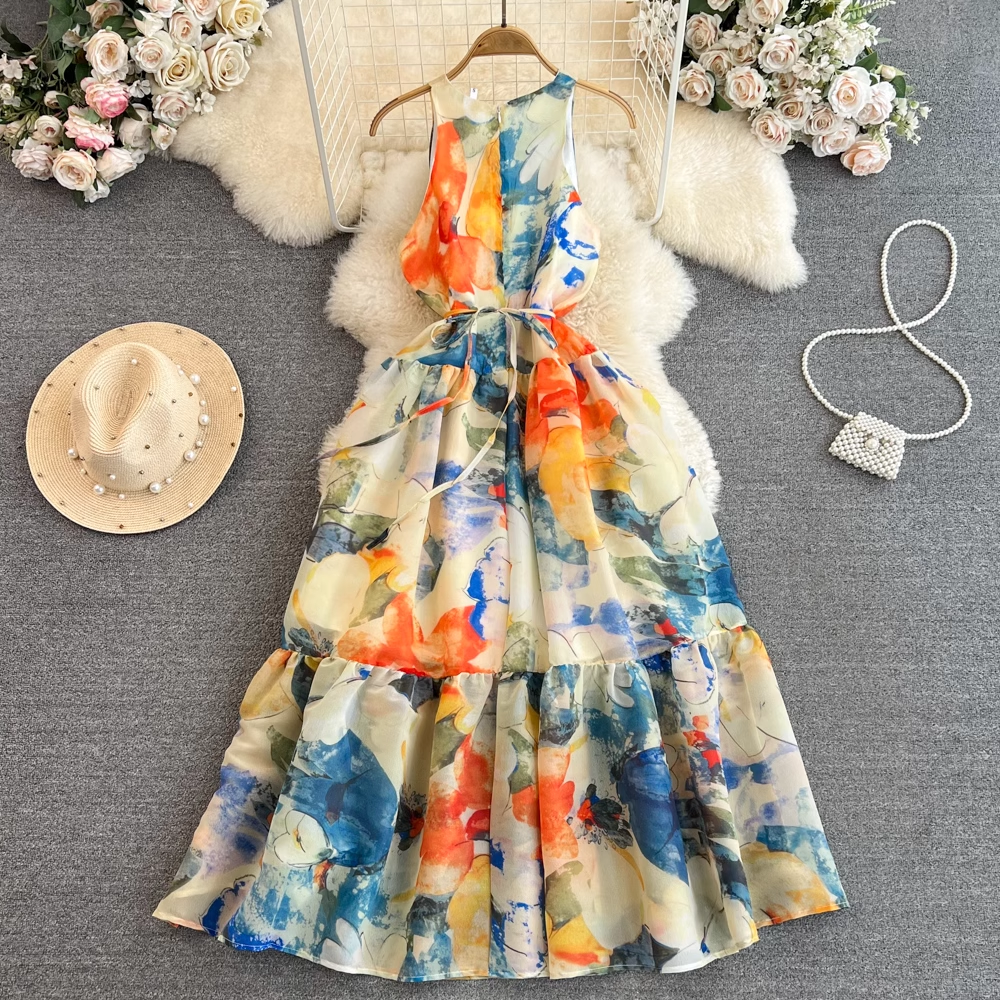 Full view of a sleeveless abstract floral print maxi dress with a tiered hem and a cinched waist, displayed on a hanger.