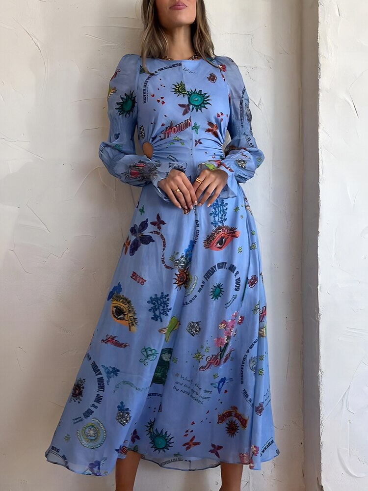 Front view of a woman in a light blue graphic print maxi dress with long, ruched sleeves and a cut-out waist.