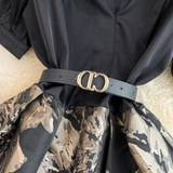 Close-up of the black belt with gold buckle on a dress