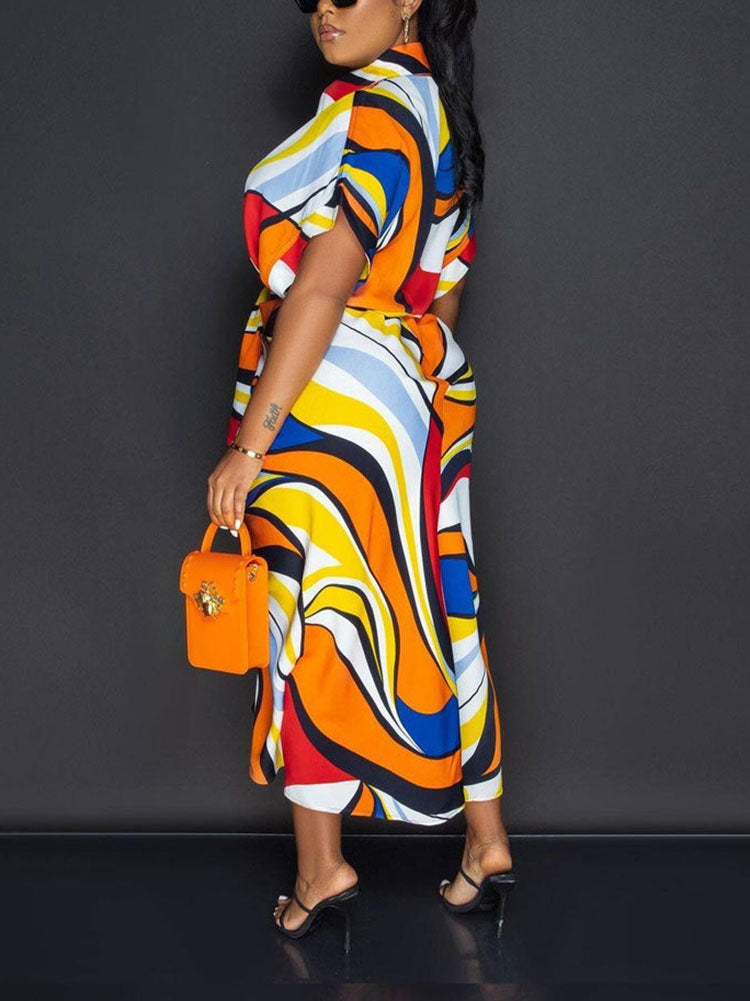 Back view of a woman wearing a flowing abstract print shirt dress.