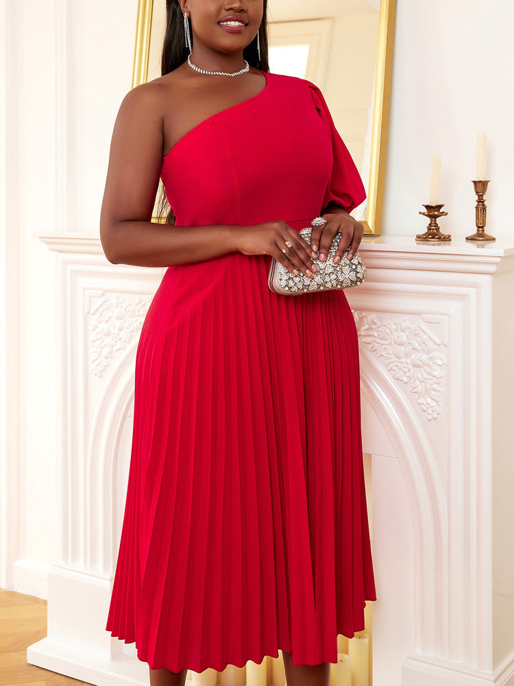Woman in a red one-shoulder dress holding a jeweled clutch.