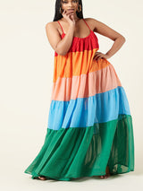 Full body shot of a woman modeling a vibrant, tiered maxi dress.