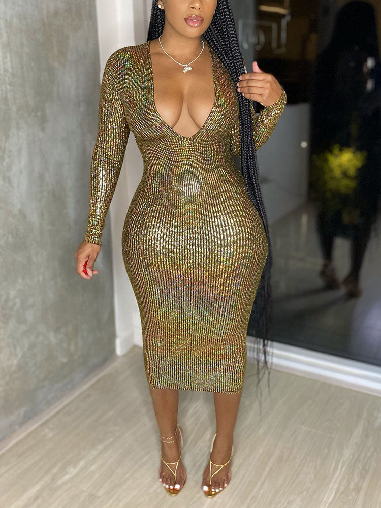 Woman wearing a gold sequined long-sleeve midi dress with a deep V-neckline.