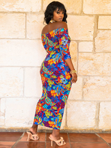 Rear view of a woman in a floral print off-the-shoulder maxi dress.