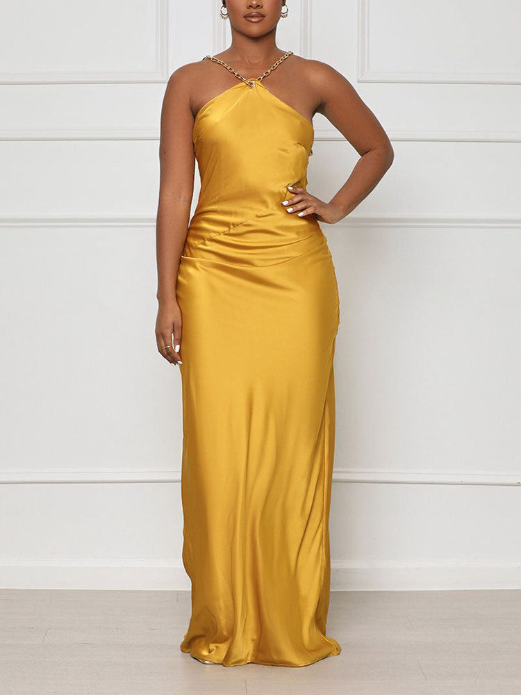 woman wearing a yellow satin halter dress with a low open back