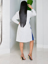 Side view of a woman in a blue and white striped shirt dress, showcasing the tie waist.