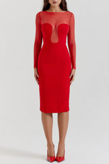 Woman wearing a red sheath dress with sheer illusion neckline and long sleeves, front view