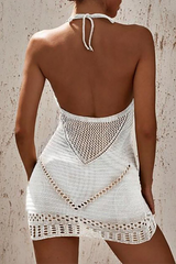 Back view of a woman in a white crochet knit mini dress, highlighting the open back and intricate knit pattern.