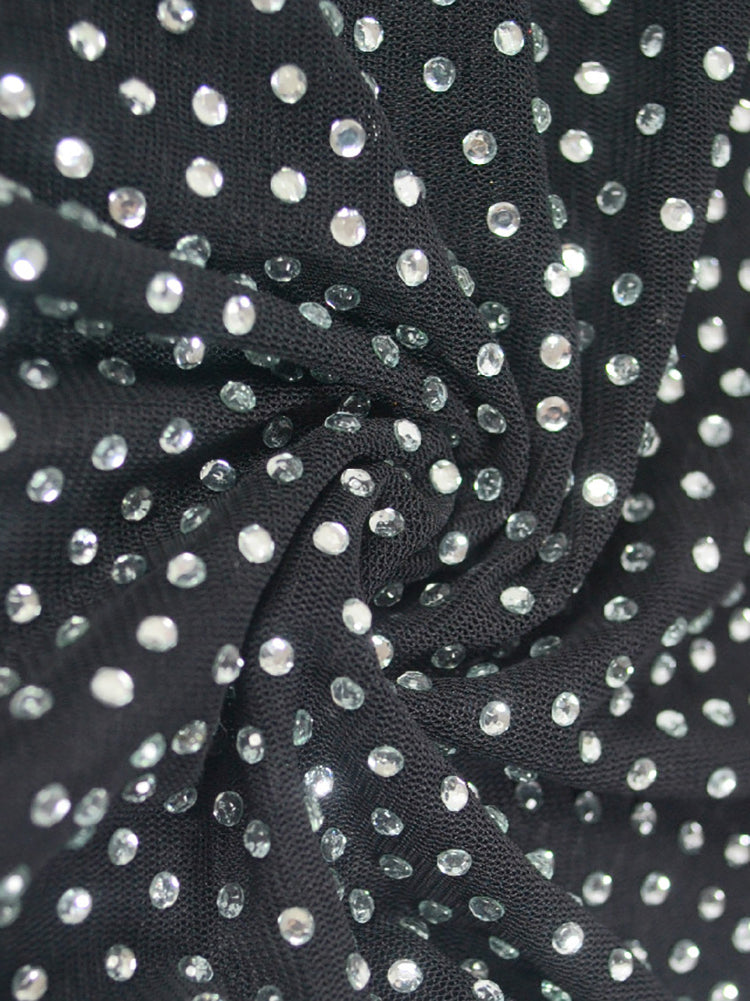 Close-up of the black mesh fabric with scattered rhinestones.