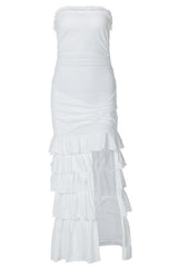 A cream strapless maxi dress with ruching and tiered ruffles, featuring a high slit.
