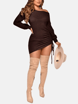 Full body shot of a model in a dark brown ribbed knit mini dress, off-the-shoulder neckline, with knee-high boots and a hat.