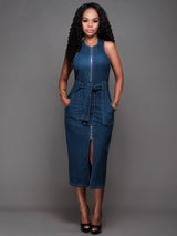 woman wearing a sleeveless denim sheath dress with a zipper front and belted waist