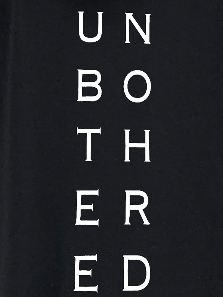 Close-up of 'Unbothered' graphic text on a black hooded dress.