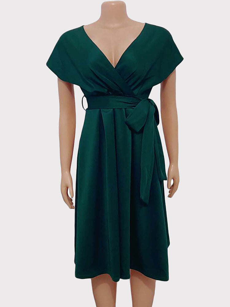 Mannequin displaying a dark green A-line midi dress with a V-neck wrap bodice and a self-tie sash.